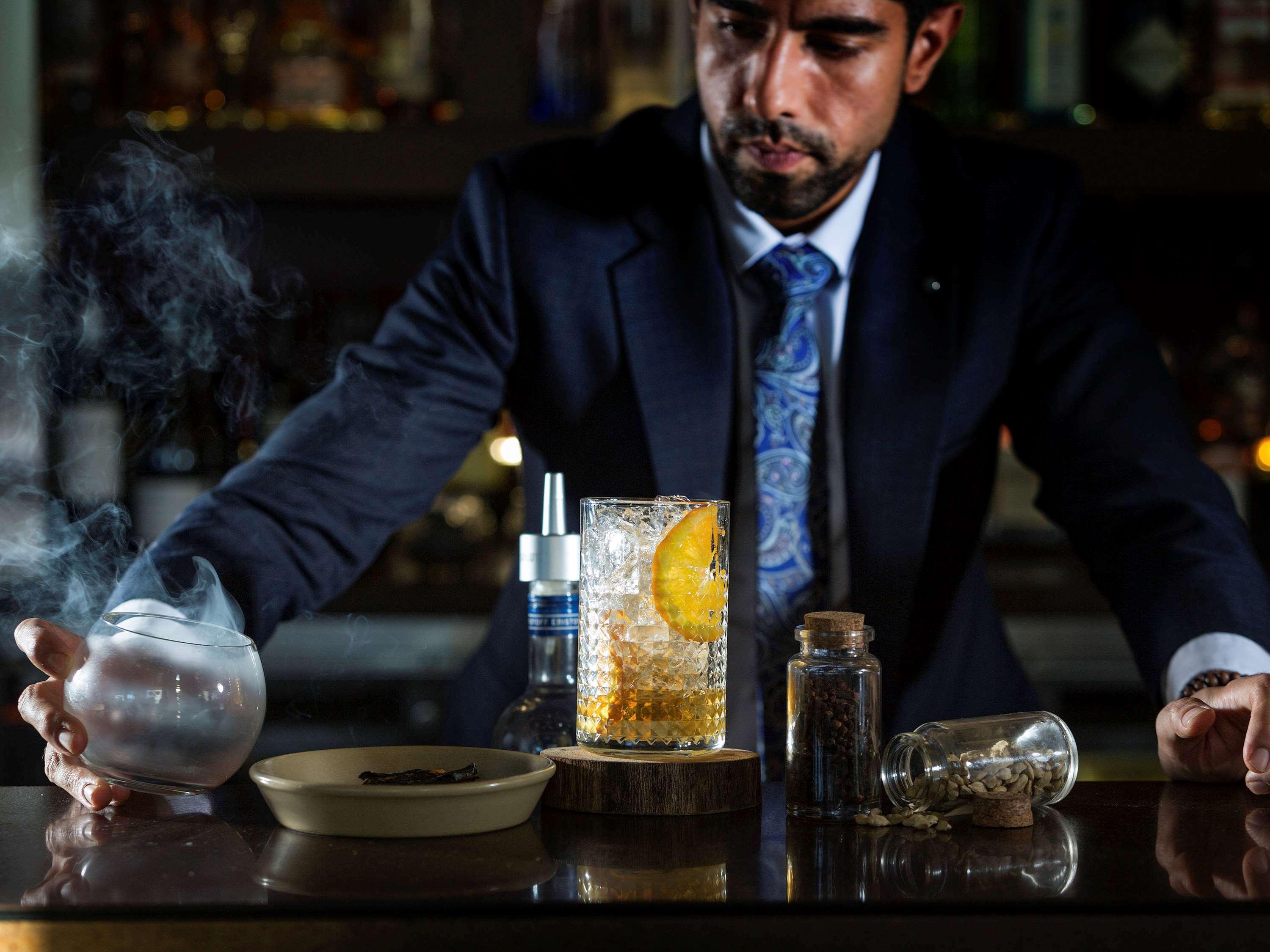 Pullman Sydney Olympic Park Hotel Bagian luar foto A bartender at work